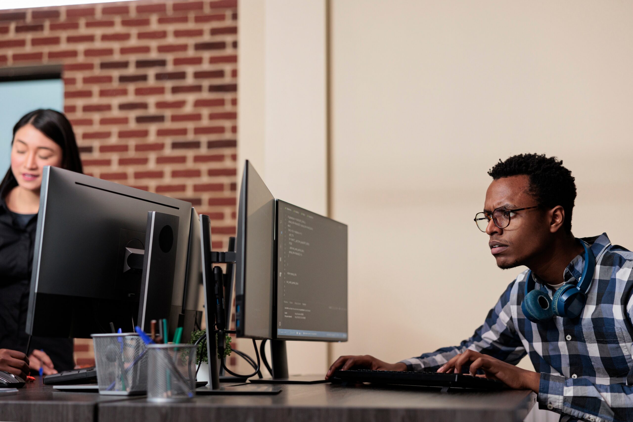 Confused man looking at code on a computer screen