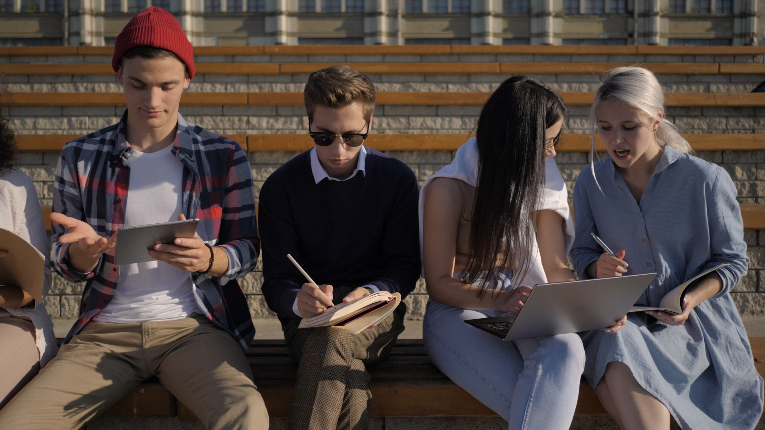 A group of friends sitting together and working on a project