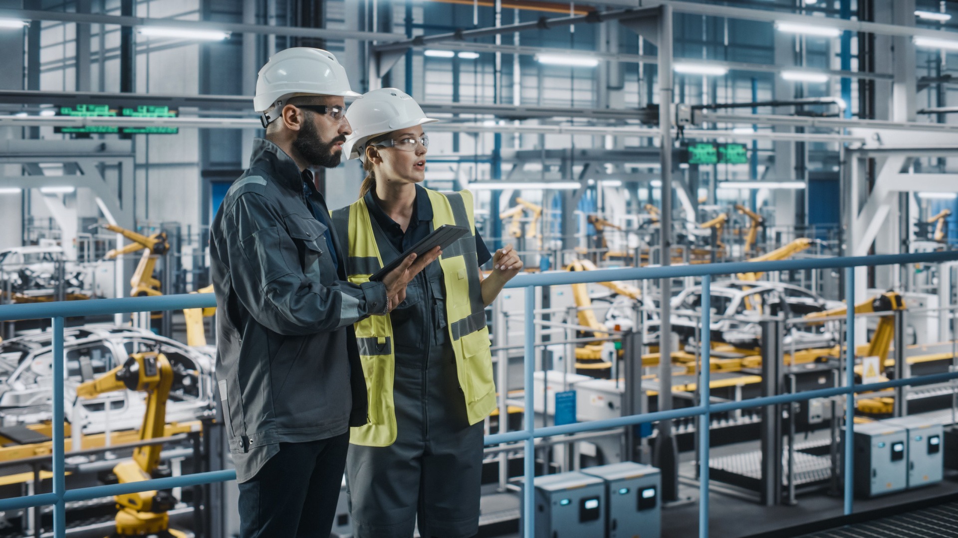 Automotive engineers having a conversation at a manufacturing plant