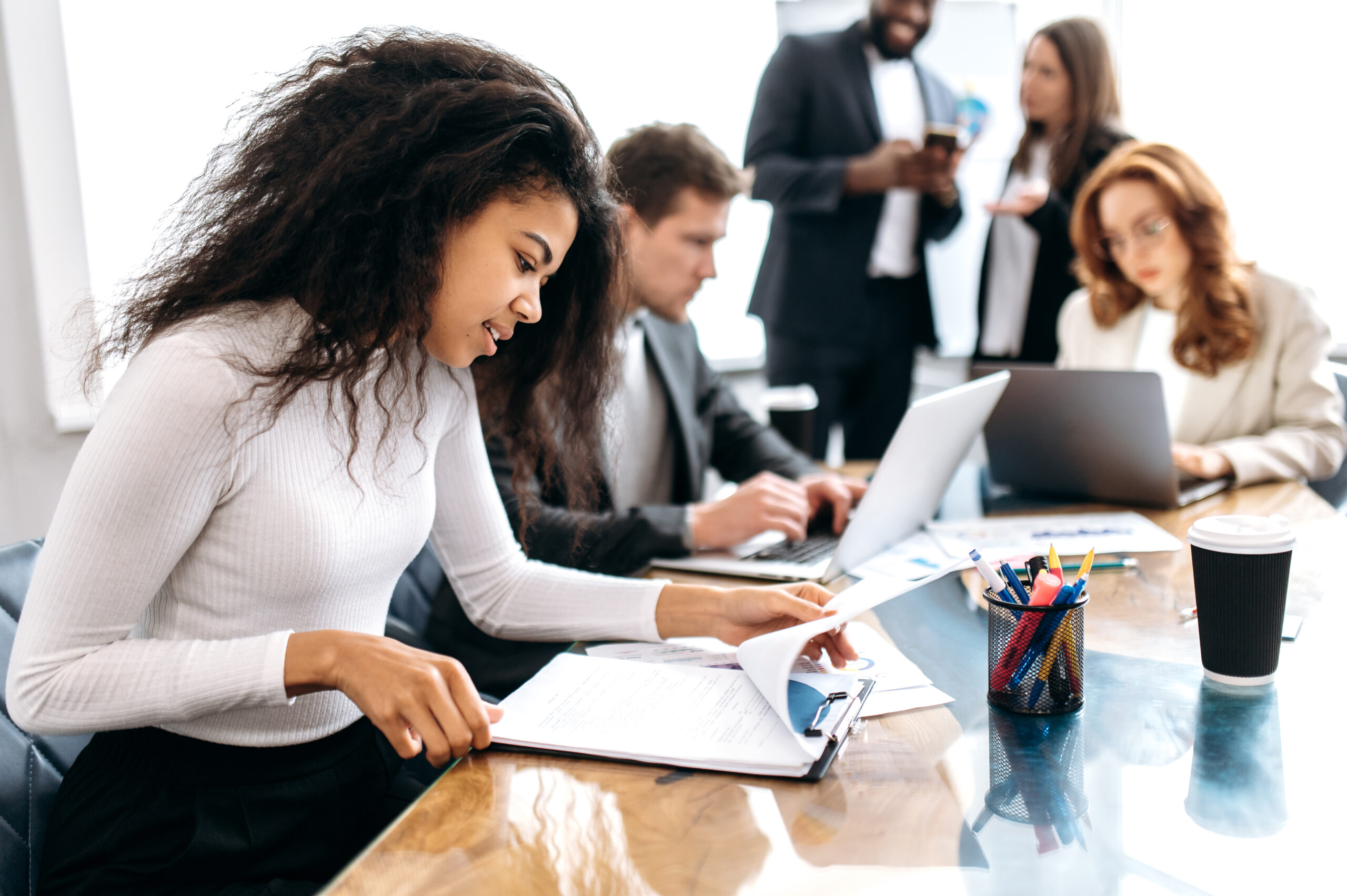 business professionals gathered around a conference table