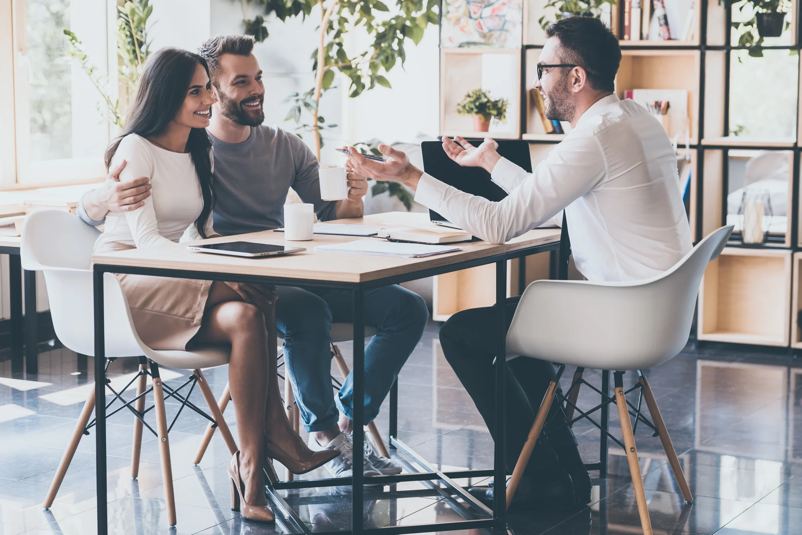 financial professional meeting with a happy couple