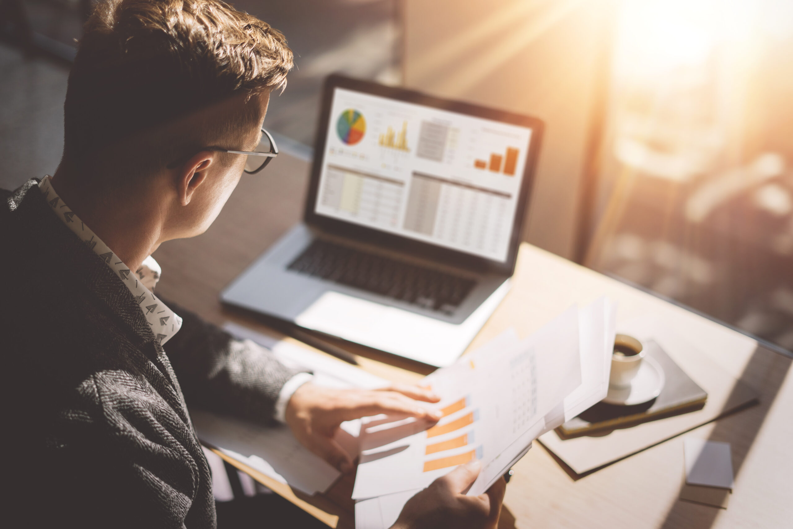 Man sitting at his computer reviewing marketing reports
