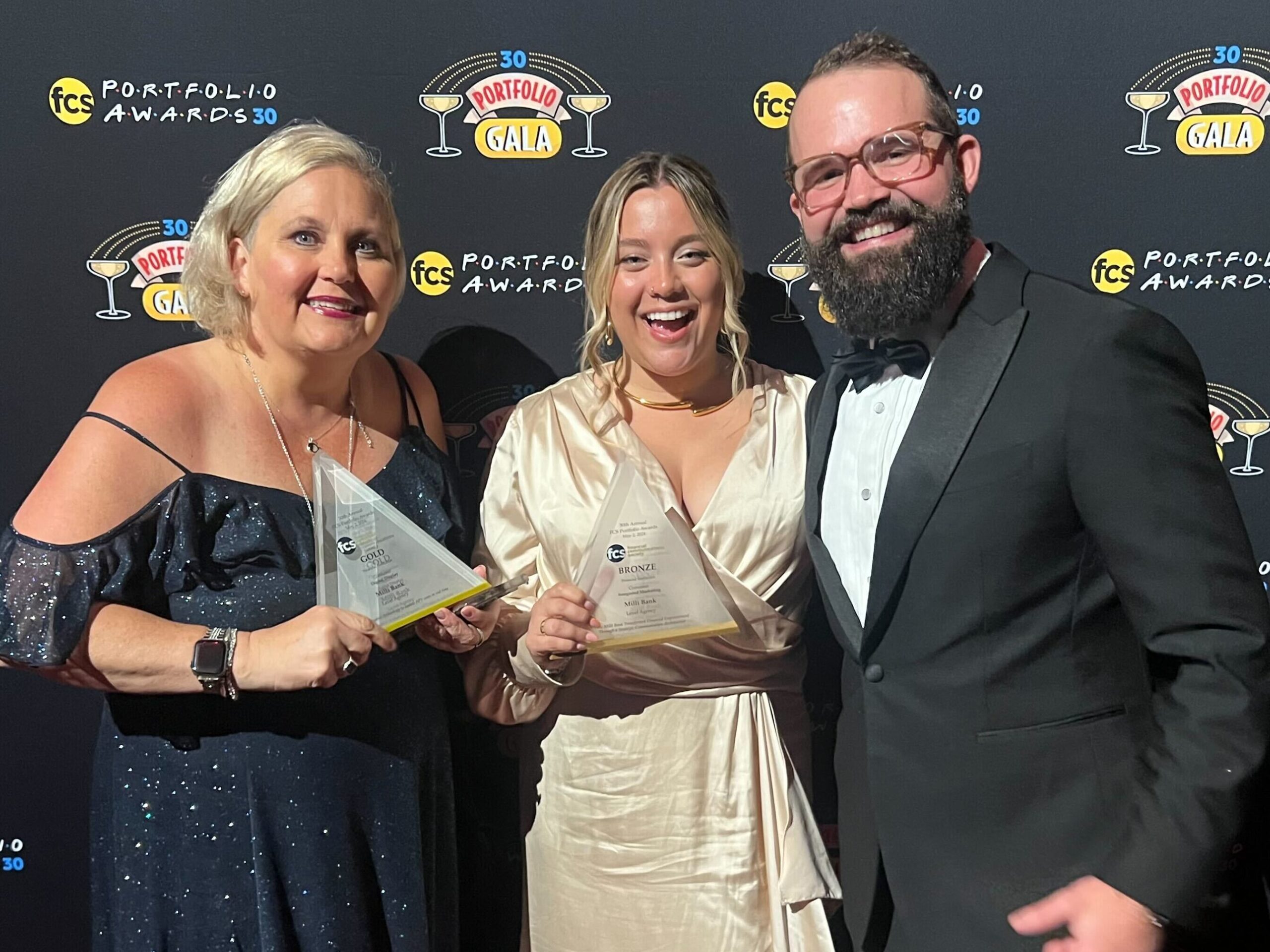 Amy Stettler, Jenna Bluedorn, and Patrick Van Gorder of Level Agency stand with their awards at the FCS Portfolio Awards.