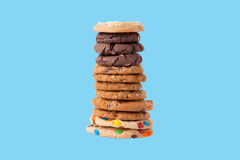 A delicious stack of various cookies against a Level Agency blue background.