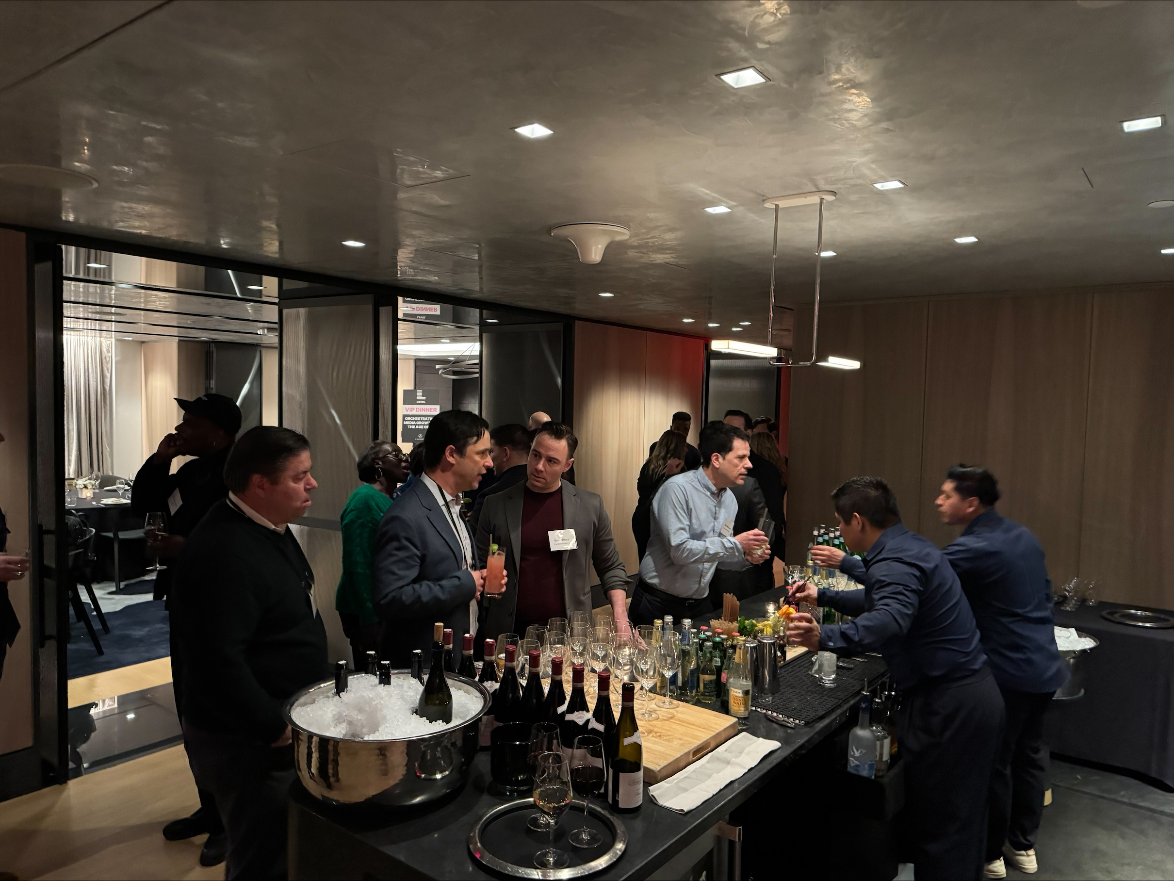 Guests talking around a bar