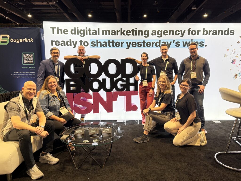 The Level Agency team at their LeadsCon 2026 booth with the Good Enough Isn't sign