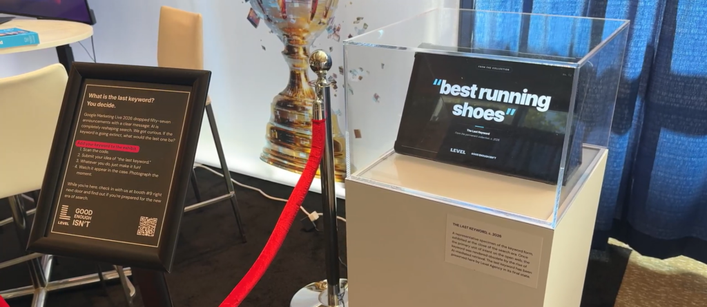 Level Agency's Last Keyword booth activation at SMX Advanced 2026 featuring a museum display case with the keyword best running shoes on screen