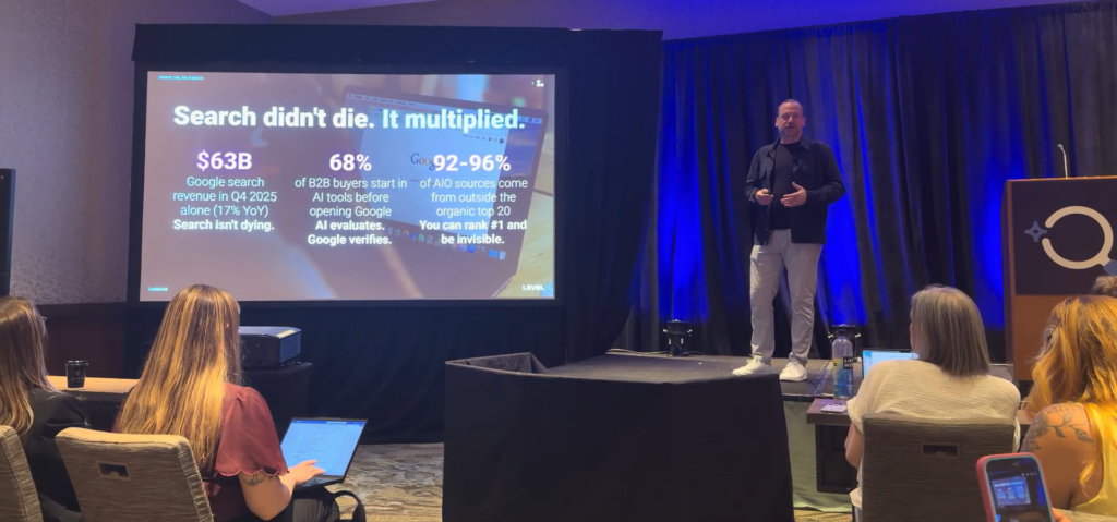 Level Agency presenter on stage at SMX Advanced 2026 with slide reading Search didn't die. It multiplied.