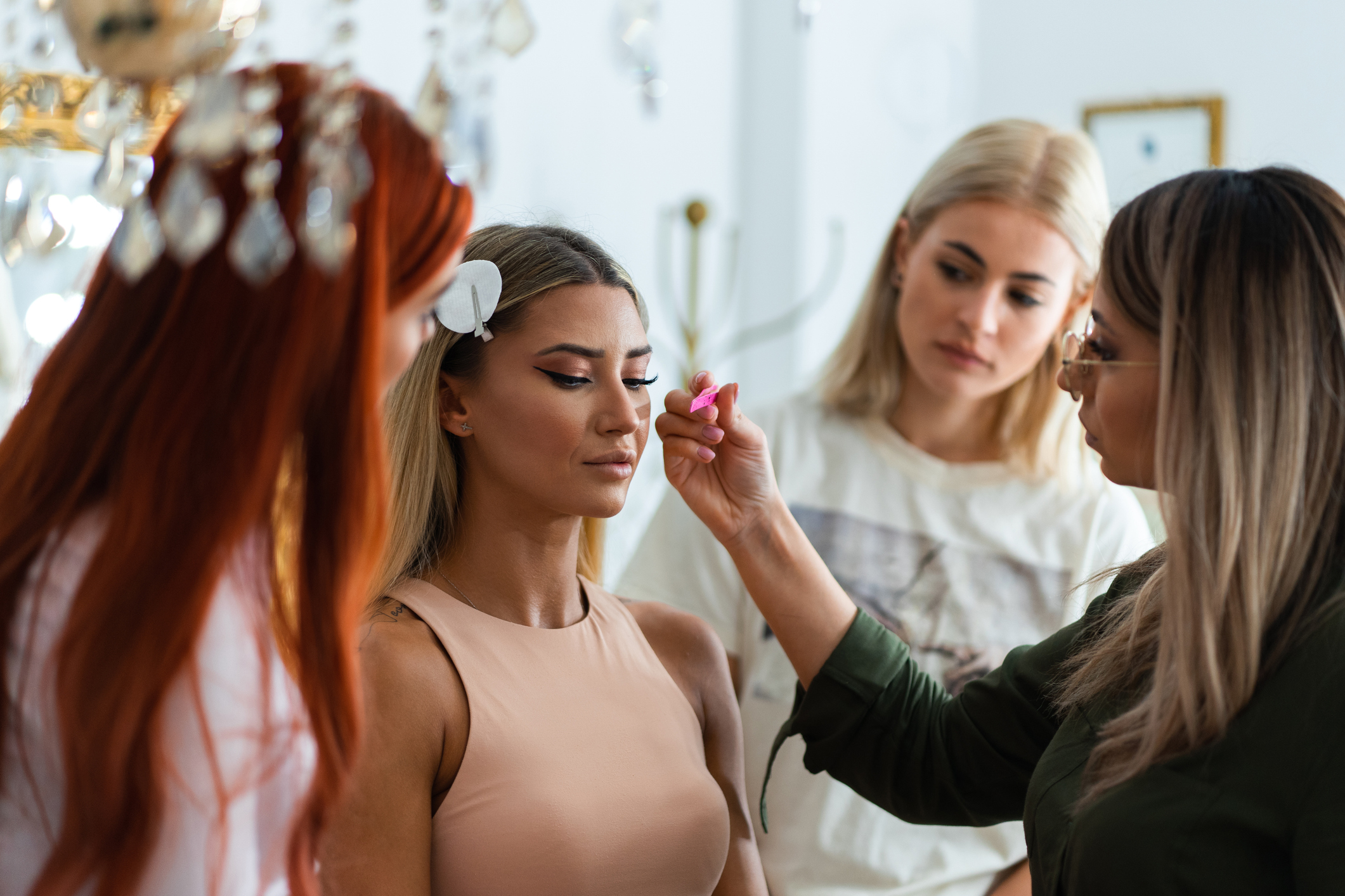 Two girls are attending the make-up masterclass. The educator is showing them on the model how to do glam make-up. Cosmetology is one of the career programs at risk under the new 2026 higher education federal regulatory changes.