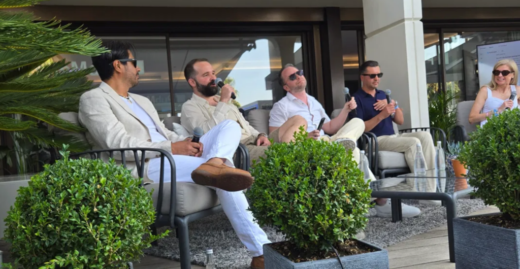 Five panelists seated with microphones on an outdoor terrace at PubMatic's Untapped Growth event during Cannes Lions 2026.