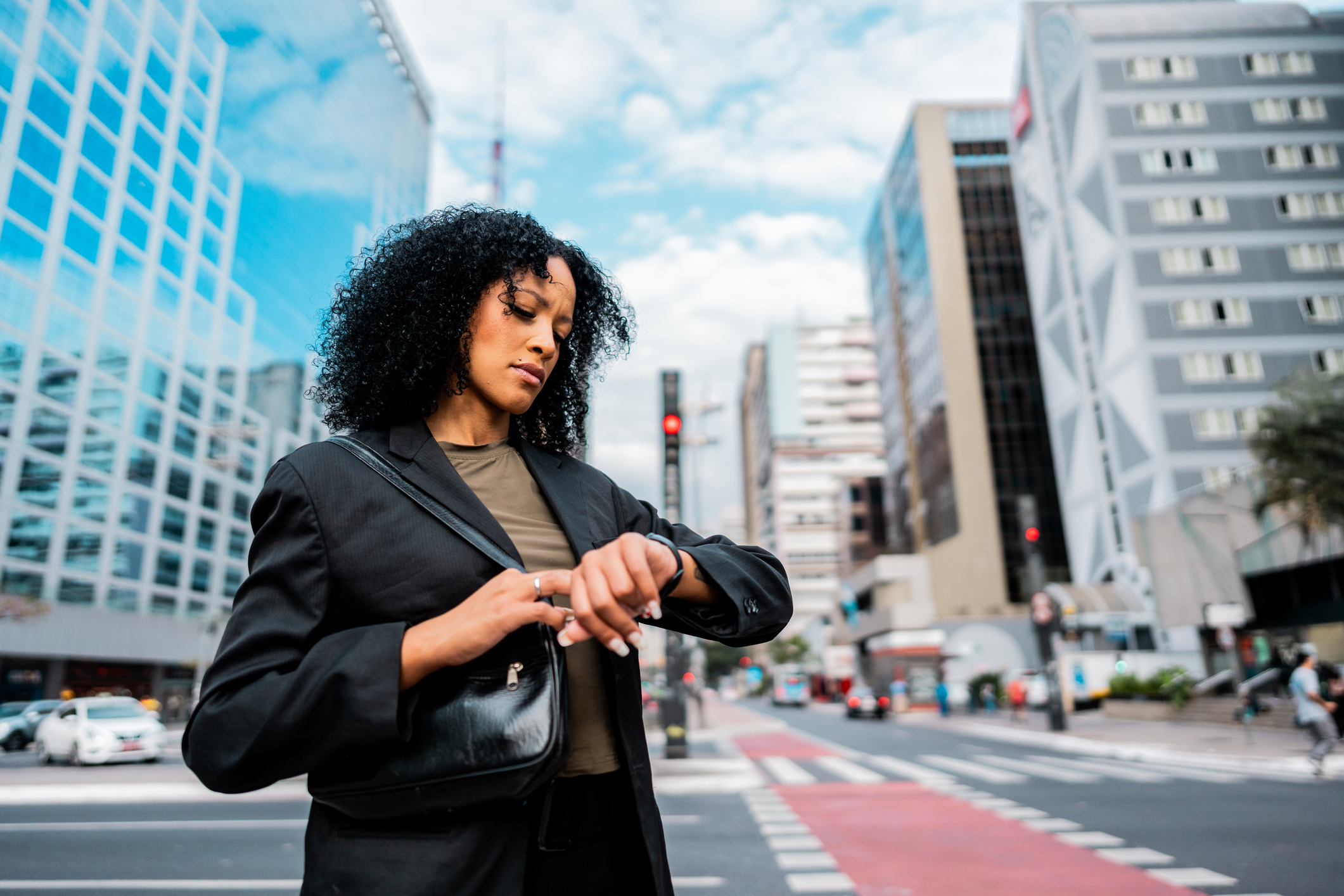 A businesswoman looking closely at her watch in a city setting, symbolizing the focus on time tracking and AI efficiency in marketing agency reporting.